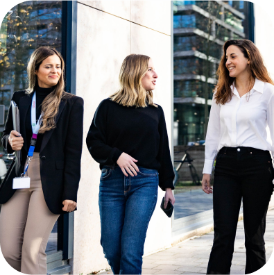 A group of business people walking in front of a building
