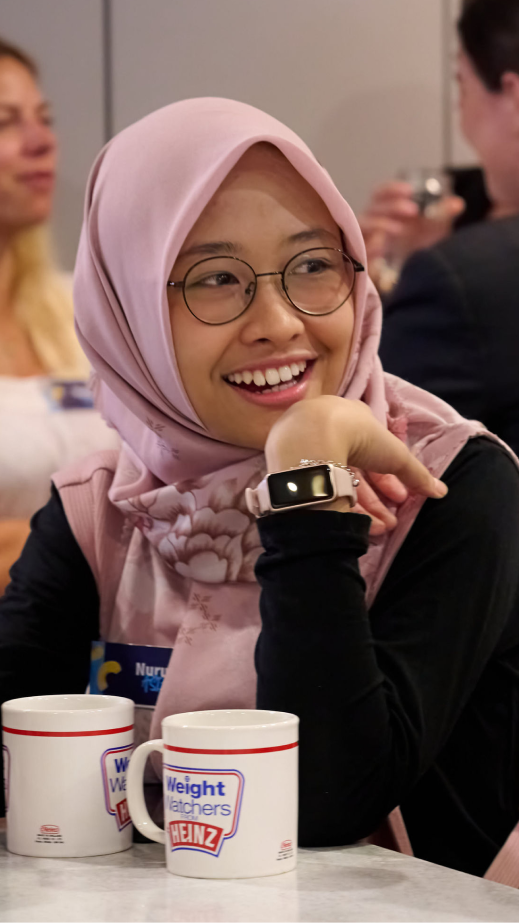 woman sitting at a table and smiling