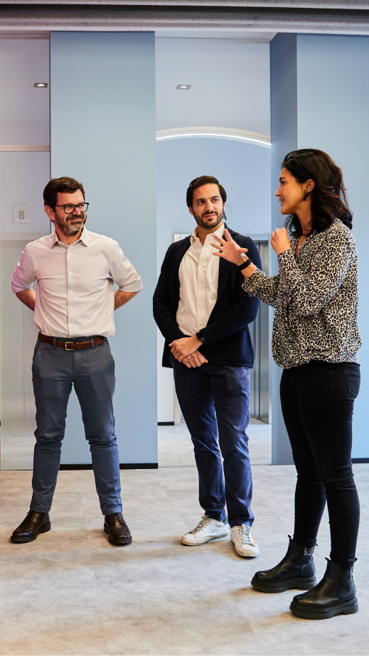 3 people standing in an office vestibule