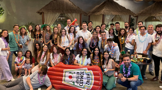 A group of people posing with a large Heinz Tomato Ketchup inflatable.